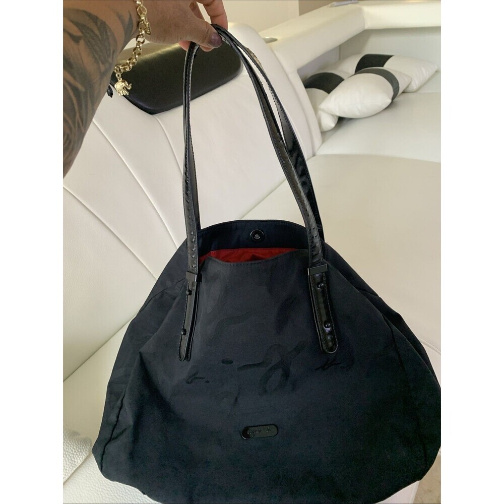 Agnès b. Voyage small black nylon bag with strap details.